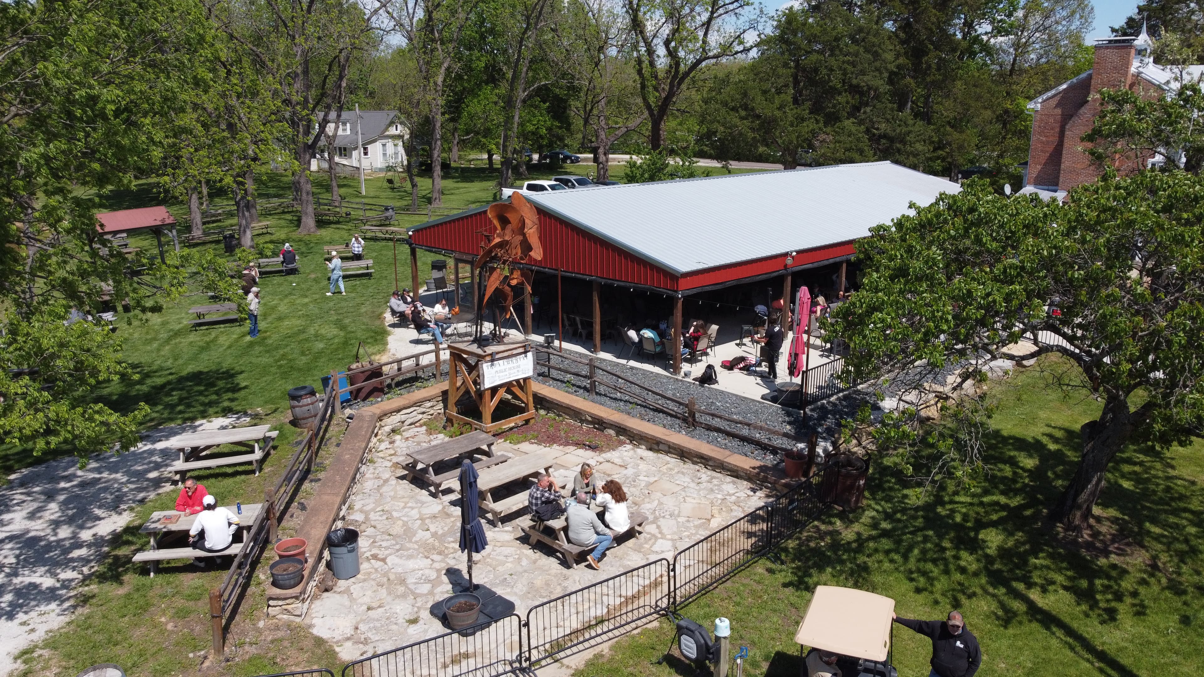 Aerial view of the Iron Turbine pavilion, patio, and lawn during the day.