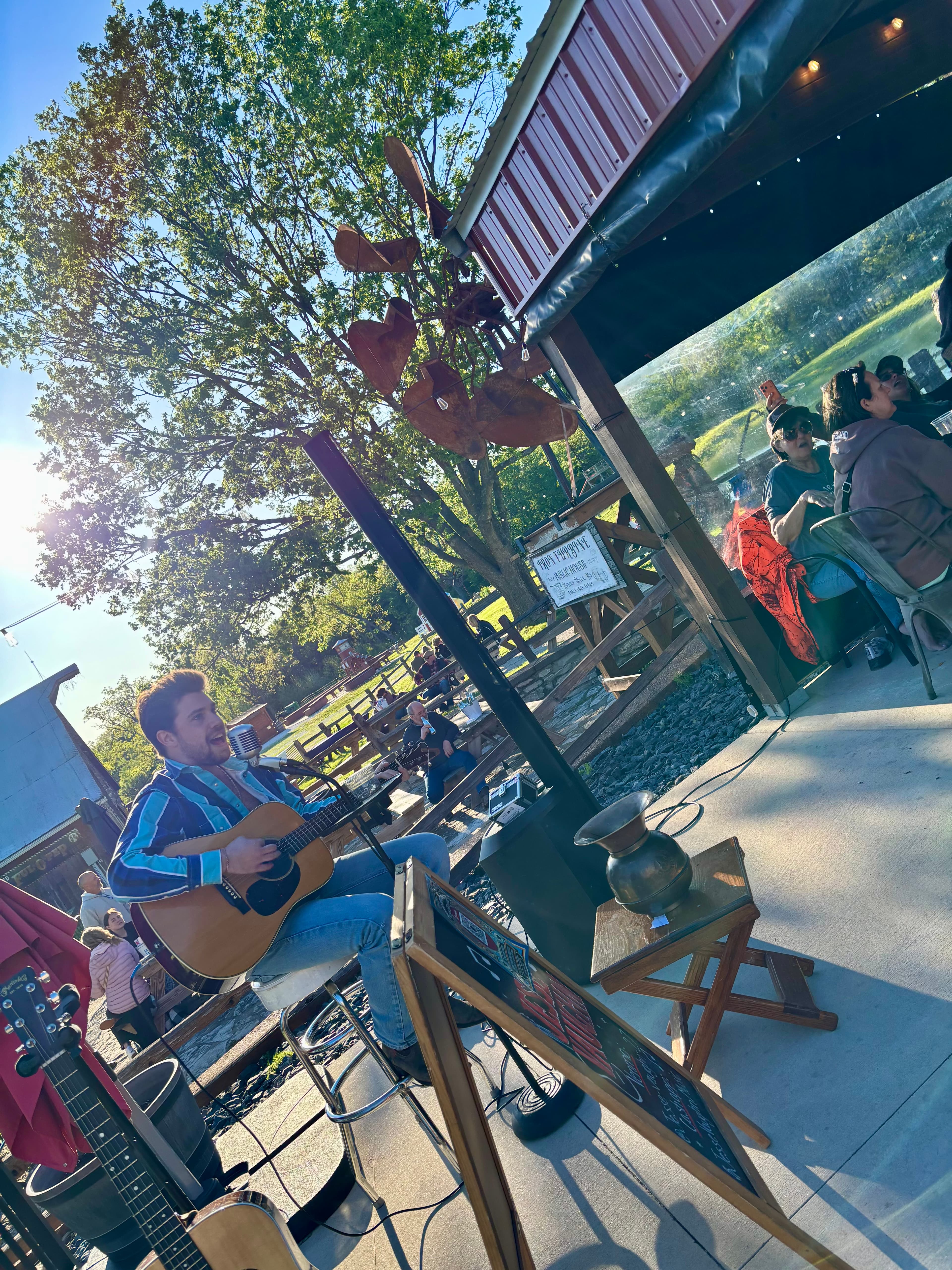 Live music on the Iron Turbine patio with guests gathered under the pavilion.